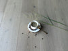 Cup and saucer with scattered coffee beans on a wooden floor