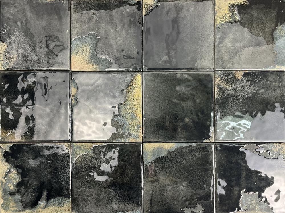 Grid of square tiles with abstract black, gray, and white patterns